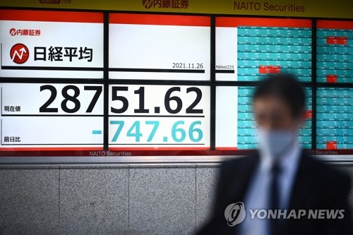 26일 일본 도쿄에서 한 남성이 증시 시황판 앞을 지나고 있다./사진=AFP연합뉴스