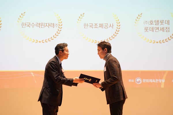 이세훈 롯데면세점 HR팀장(우측)이 유병채 문화체육관광부 문화예술정책실장(좌측)으로부터 여가친화기업 인증패를 받는 모습 / 사진=롯데면세점