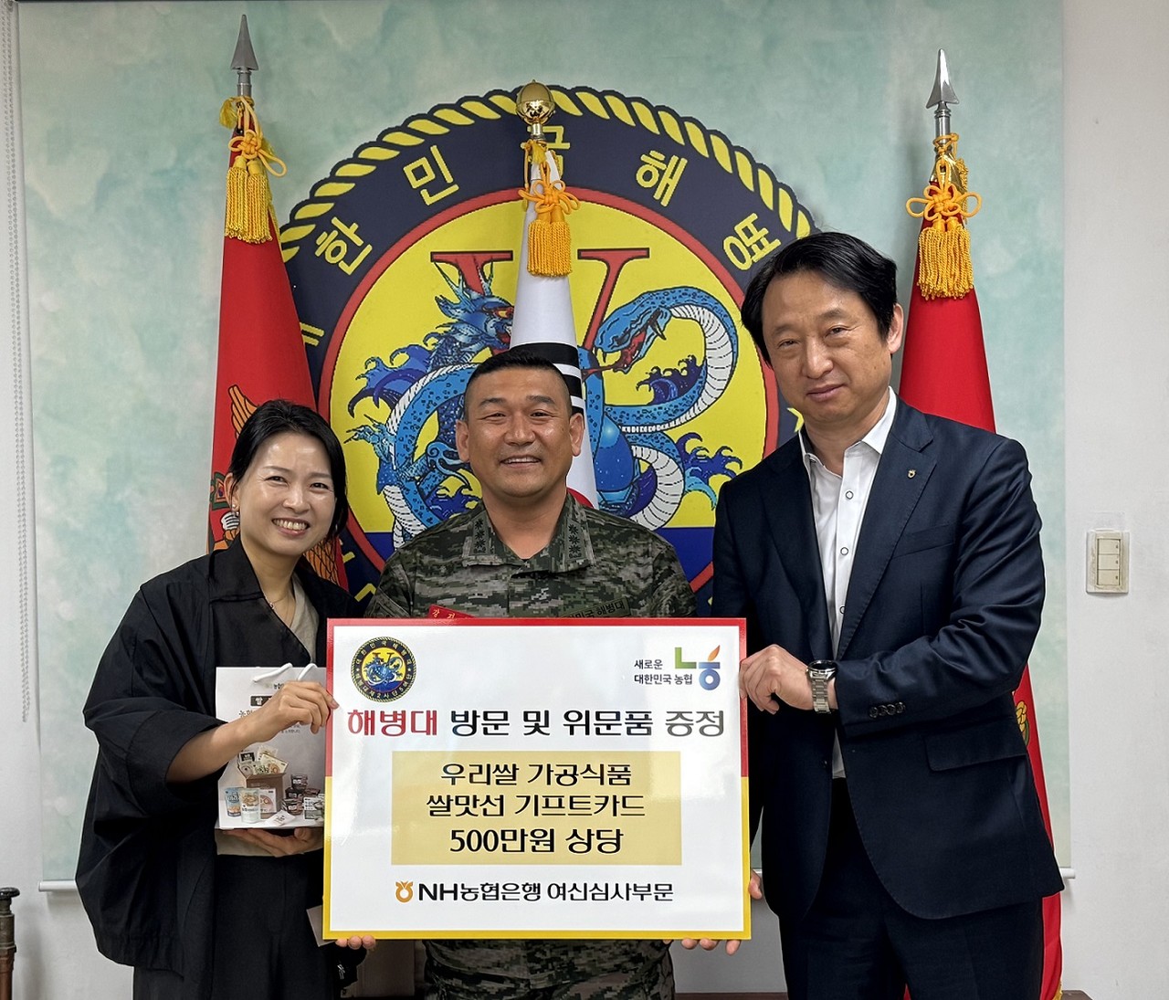 함상수  농협은행 여신심사부 부장(오른쪽)이 19일 인천 강화에 위치한 해병대 제2사단 5여단을 방문해 위문품을 증정하고 강지혁 여단장(가운데)과 기념촬영을 했다. / 사진=NH농협은행